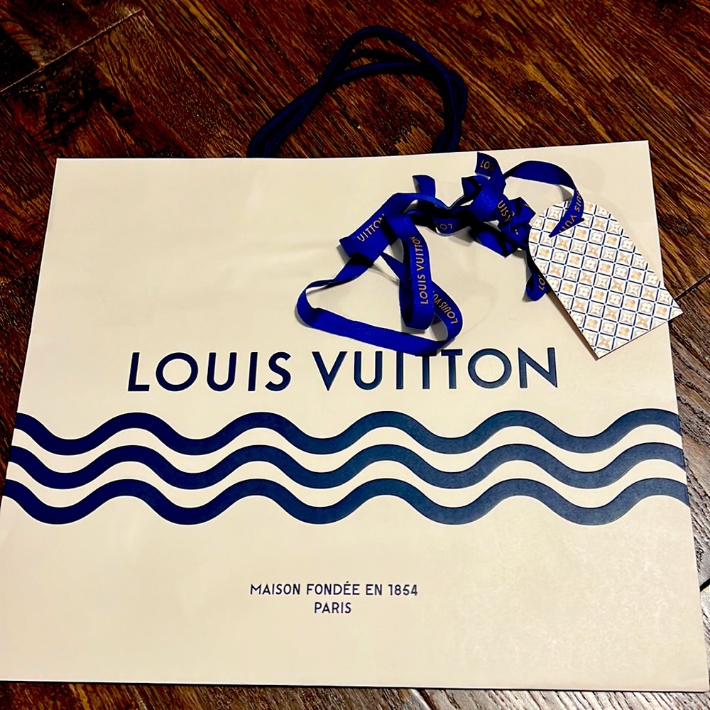 Authentic Louis Vuitton shopping bag with ribbon and tag. From Nice, France
